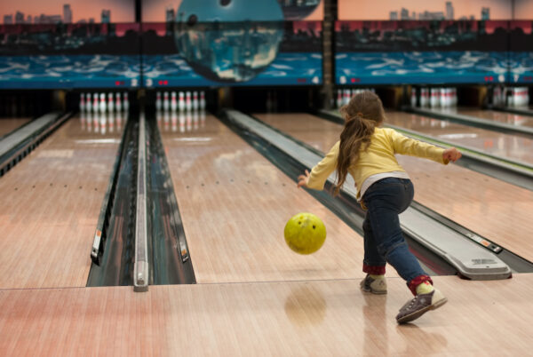 A child participating in a bowling game.