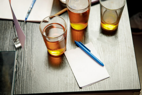 The pub quiz concept. Beer glass and blank paper for answers