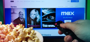 Kyiv. Ukraine. 10.11.2023: Person watching HBO MAX on TV with popcorn and remote control. Stock editorial photo.