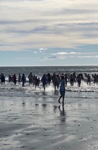 people in water during polar beach plunge kennebunk maine