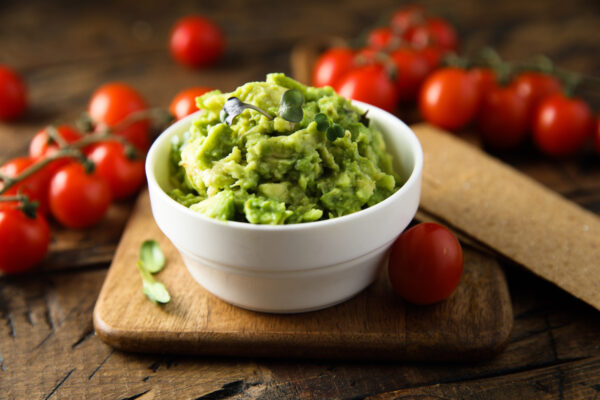 Homemade avocado dip with ripe tomatoes