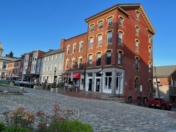 old port buildings and cobblestone street with sunlight