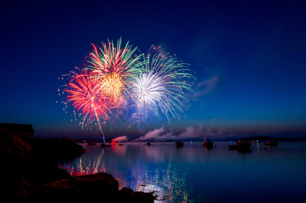 Fireworks explode over the water in Maine.