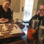 Two women playing Scrabble.
